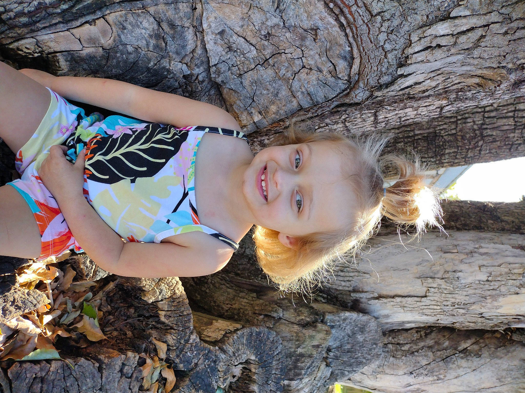 Wynter is registered to the contest to win money with this photo: blond, child, flash_photography, fun, grass, happy, human_leg, joy, leisure, people_in_nature, person, plant, smile, soil, swimwear, thigh, toddler, tree, trunk, water