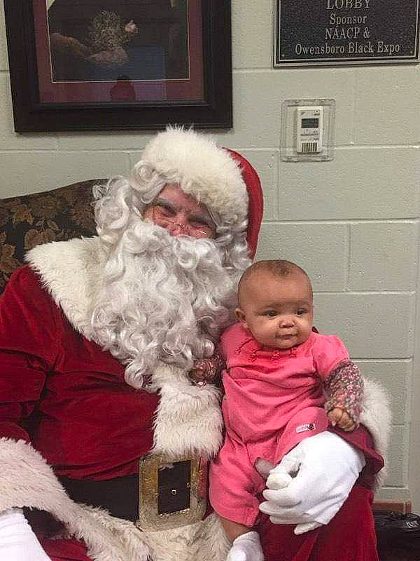 Nalanah is registered to the contest to win money with this photo: beard, child, christmas, christmas_eve, facial_hair, fictional_character, fur, holiday, lap, person, santa_claus, toddler