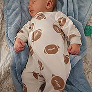 Aerian Walker joined the competition — help win amazing prizes! baby, sleeping, blanket, blue, onesie, football_pattern, infant, cute, soft, cozy, child, bed, comfort, peaceful, small_hands, portrait, indoors, rest, sleepwear, relaxation