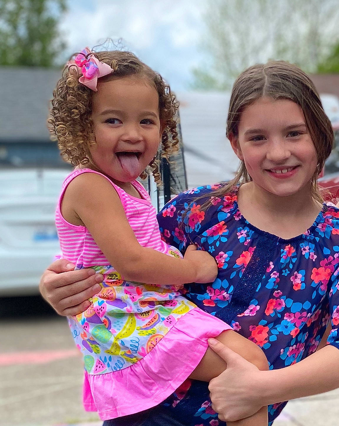 Gabriella is registered to the contest to win money with this photo: child, family, fun, gesture, happy, interaction, joy, leisure, party, people, person, pink, play, recreation, sibling, smile, summer, toddler, vacation