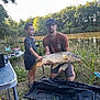 child, adult, fish, fishing, lake, outdoor, nature, grass, trees, water, fishing_rod, person, summer, catch, recreation, vacation, equipment, happy, man, boy