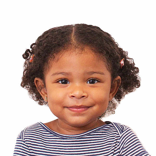 Azalea is registered to the contest to win money with this photo: child, toddler, smile, curly_hair, striped_shirt, portrait, face, earrings, happy, cute, innocence, studio, white_background, person, headshot, young_child, fashion, hair_accessories, closeup, expression
