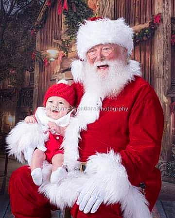 Joseph is registered to the contest to win money with this photo: christmas, christmas_decoration, fictional_character, fur, headwear, holiday, lap, person, santa_claus