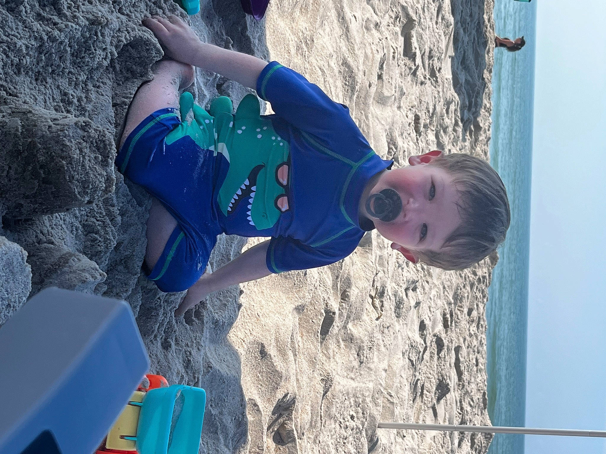 Brody joined the competition — help win amazing prizes! adventure, beach, blue, child, electric_blue, freezing, fun, leisure, people_in_nature, person, play, recreation, rock, rope, sand, sky, soil, sport_climbing, toddler, vacation
