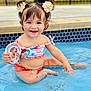 toddler, child, pool, water, smile, toy, hair_clips, sitting, summer, happy, cute, playful, swimwear, skin, outdoor, fun, baby, person, blue, splash