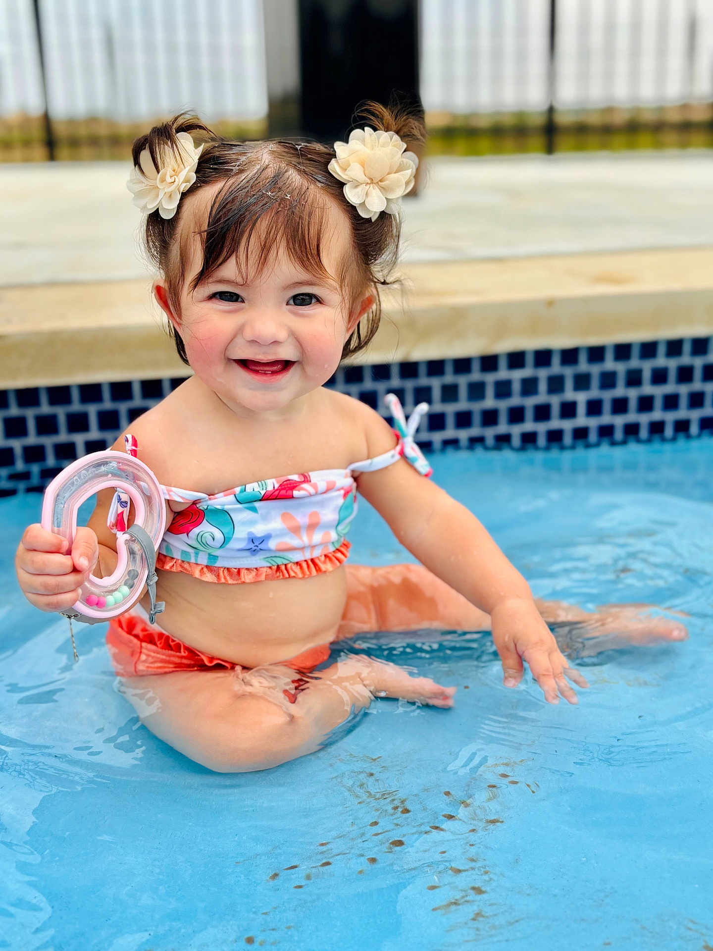 Zaya joined the competition — help win amazing prizes! toddler, child, pool, water, smile, toy, hair_clips, sitting, summer, happy, cute, playful, swimwear, skin, outdoor, fun, baby, person, blue, splash