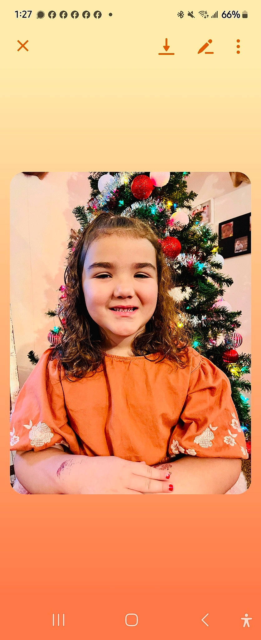 Evelyn is registered to the contest to win money with this photo: christmas_decoration, christmas_ornament, christmas_tree, event, eye, fashion_accessory, fun, happy, headpiece, holiday, holiday_ornament, interior_design, joy, laugh, ornament, peach, person, sleeve, smile, toddler