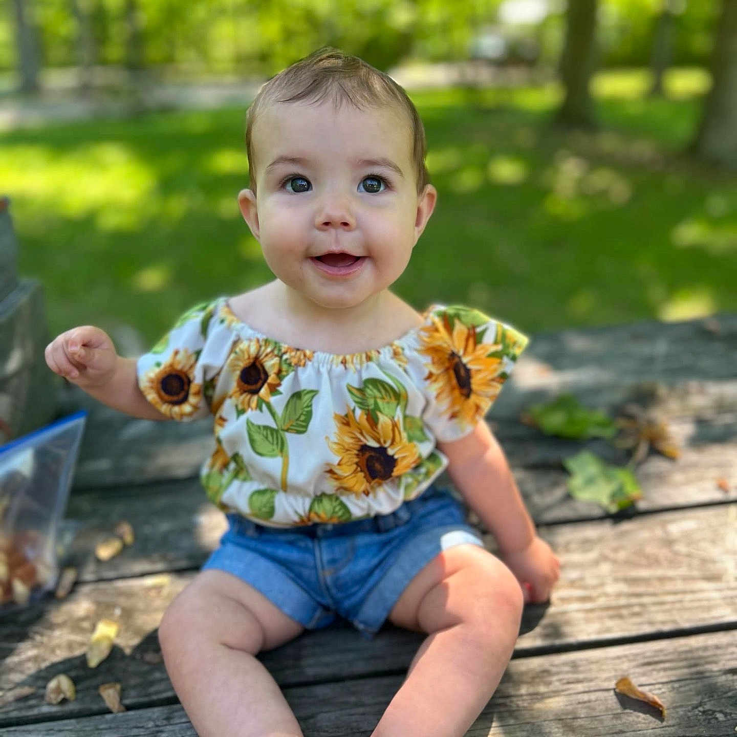 Oaklee is registered to the contest to win money with this photo: baby, backyard, clothing, dress, face, grass, head, herbal, herbs, nature, outdoors, pants, person, photography, plant, portrait, shorts, sitting, vegetation, yard