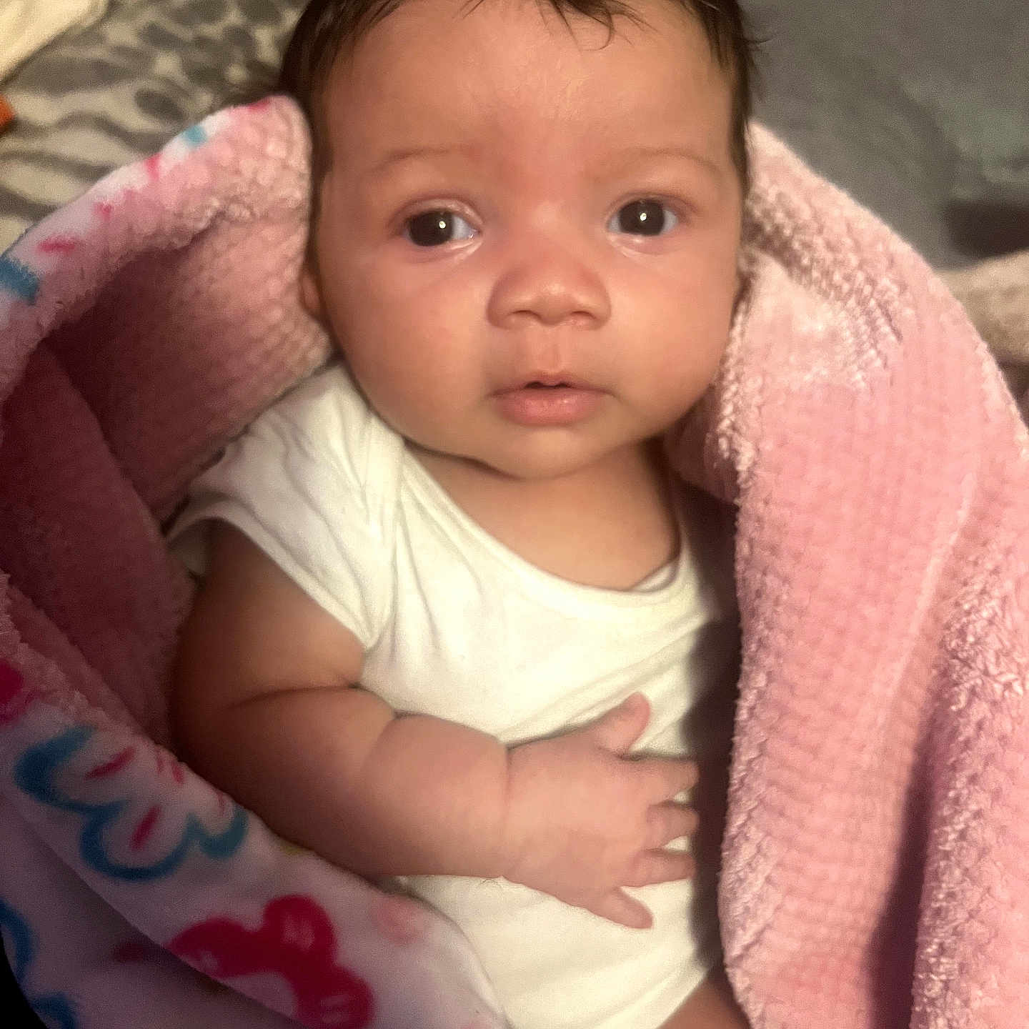 Ke'Nylah joined the competition — help win amazing prizes! baby, infant, blanket, pink, white_clothing, wrapped, cute, face, eyes, hand, soft_texture, bed, indoor, portrait, child, newborn, skin, hair, expression, cozy