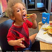 Ke'Aire joined the competition — help win amazing prizes! black_chair, burger, casual, child, curly_hair, eating, fast_food, food, french_fries, happy, indoor, kid, meal, milk_carton, play_area, red_shirt, restaurant, snack, table, toddler