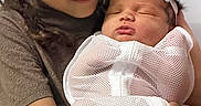 Keashawn is registered to the contest to win money with this photo: child, baby, newborn, braided_hair, sleeping, holding, love, family, tender_moment, mesh_blanket, white_clothing, portrait, indoor, closeup, warmth, caring, happy, person, cute, sibling