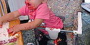 Phoebe is registered to the contest to win money with this photo: baby, barefoot, cake, child, clutter, curious, expression, face_paint, floor, food, high_chair, indoor, kitchen, leggings, messy, pink_shirt, plastic_high_chair, table, toddler, unicorn_pattern
