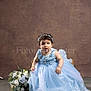 Bea Valeria is registered to the contest to win money with this photo: child, baby, toddler, blue_dress, gown, headband, floral_headband, bouquet, flowers, studio_portrait, sitting, necklace, bracelet, expressive_face, brown_background, floor, photography, curly_hair, cute, chair