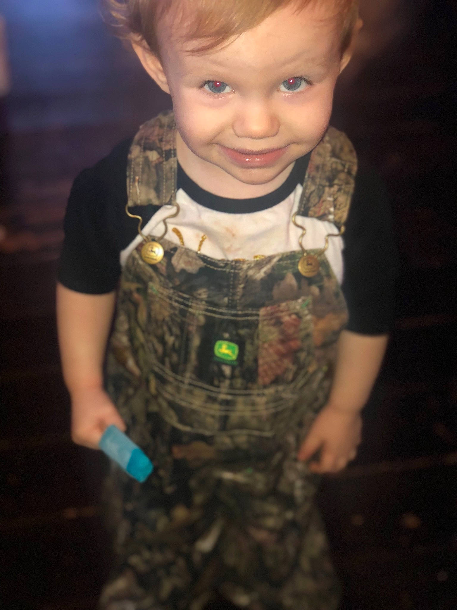 Kennedy is registered to the contest to win money with this photo: baby, baby_toddler_clothing, brown_hair, camouflage, child, eye, flash_photography, flooring, fun, gesture, happy, iris, joy, military_camouflage, nose, pattern, person, skin, sleeve, smile