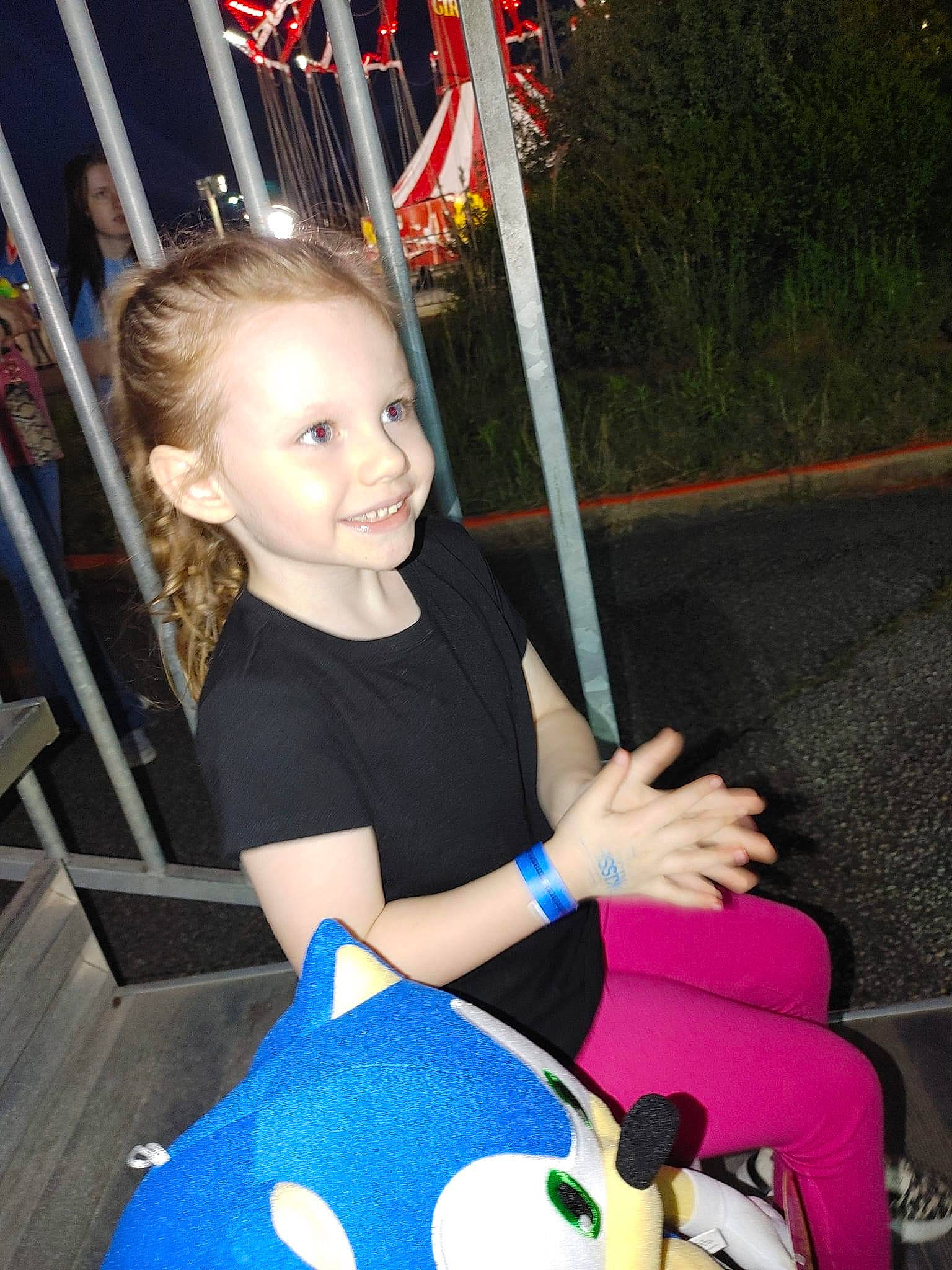 Kennedy is registered to the contest to win money with this photo: automotive_wheel_system, birthday, chair, child, event, flag, fun, happy, human_body, joy, leisure, party, person, play, recreation, sitting, smile, t_shirt, toddler, tree