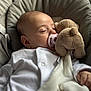 Hazel is registered to the contest to win money with this photo: baby, sleeping, pacifier, plush_toy, teddy_bear, blanket, white_clothing, infant, child, cushion, seat, indoors, peaceful, soft_lighting, portrait, closeup, cute, resting, comfort, cozy