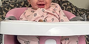 Hazel joined the competition — help win amazing prizes! baby, infant, smiling, pink_onesie, baby_seat, high_chair, ingenuity_brand, face, happy, child, cute, indoor, cushions, patterned_background, person, seated, clothing, head, eyes, mouth