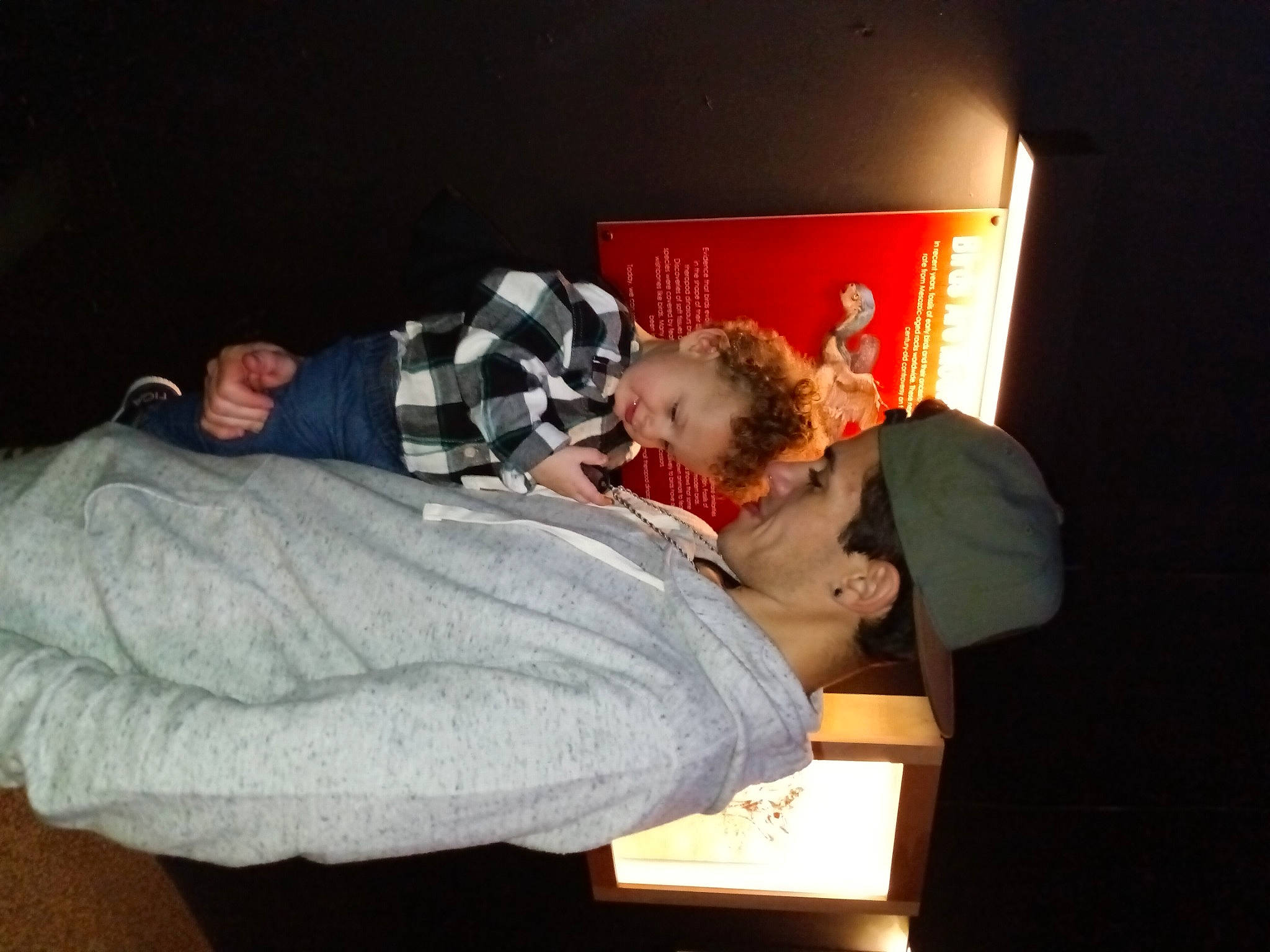 King is registered to the contest to win money with this photo: comfort, event, fun, lap, linens, person, room, sitting, smile, toddler