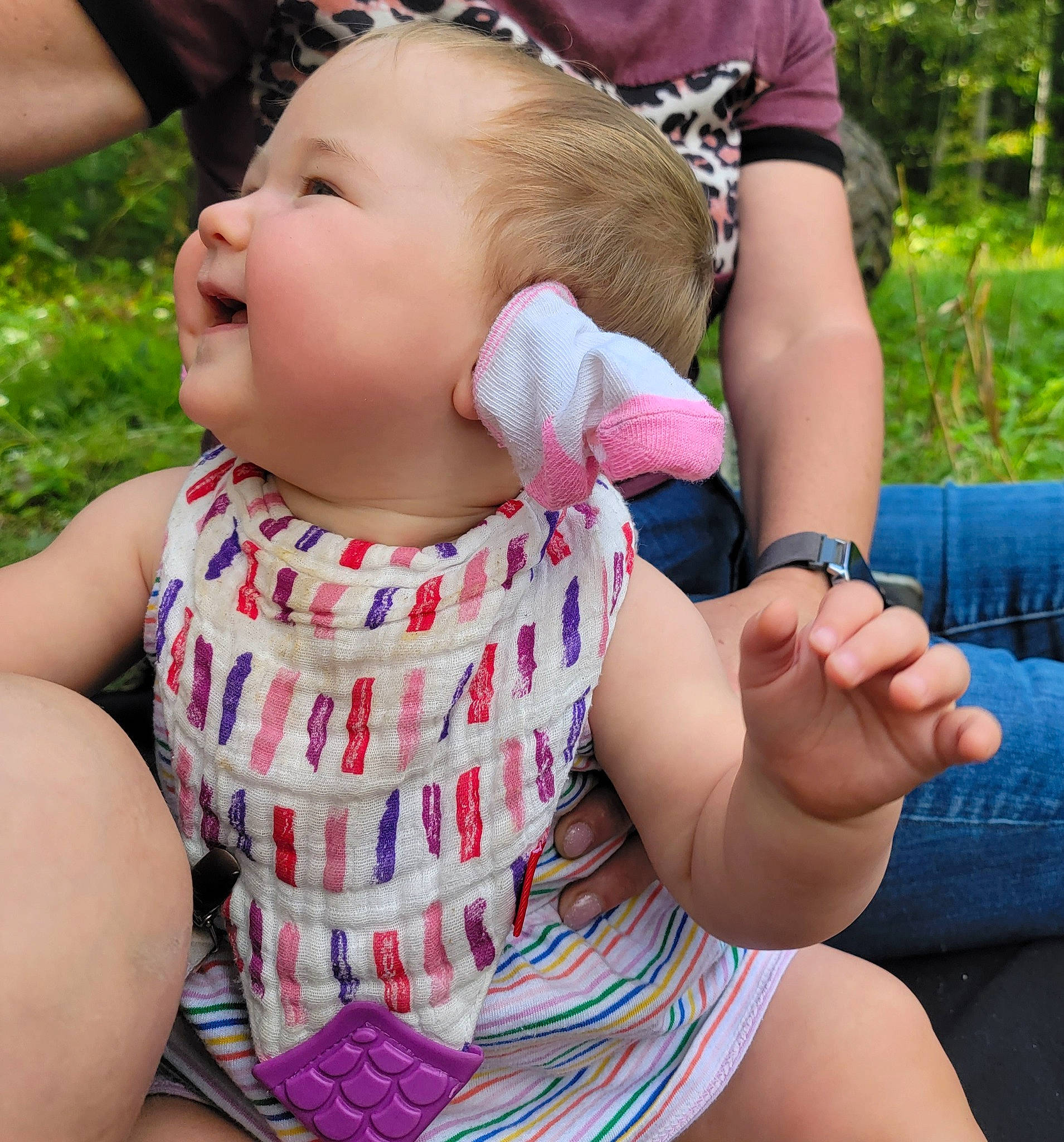 Delyla is registered to the contest to win money with this photo: baby, baby_toddler_clothing, child, finger, fun, gesture, grass, hand, happy, head, leisure, lip, pattern, person, pink, plant, recreation, skin, thigh, thumb