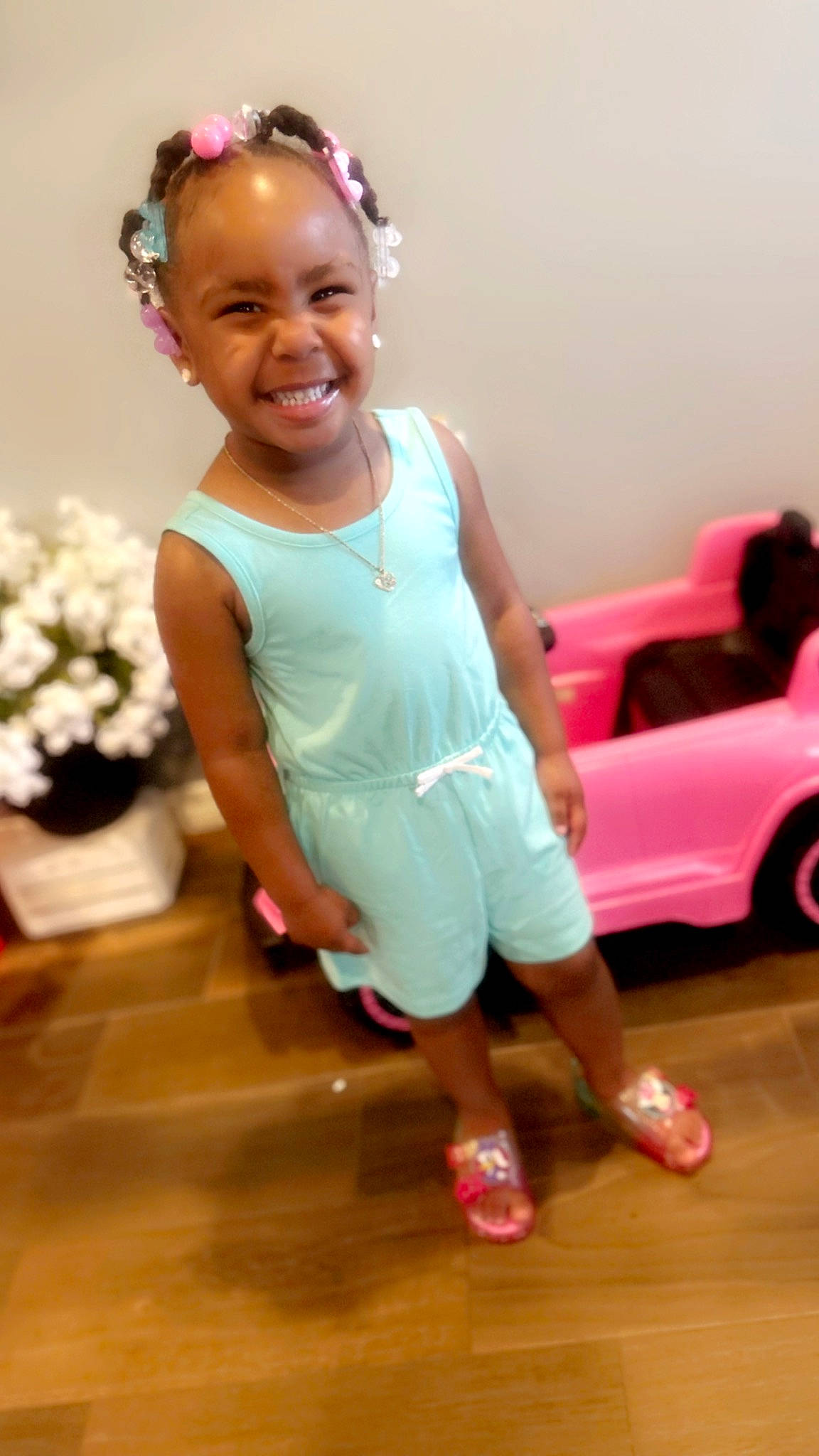 Rileigh is registered to the contest to win money with this photo: arm, baby_toddler_clothing, beauty, car, child, eye, flooring, flower, flowerpot, fun, happy, joy, motor_vehicle, person, pink, skin, smile, standing, tire, toddler