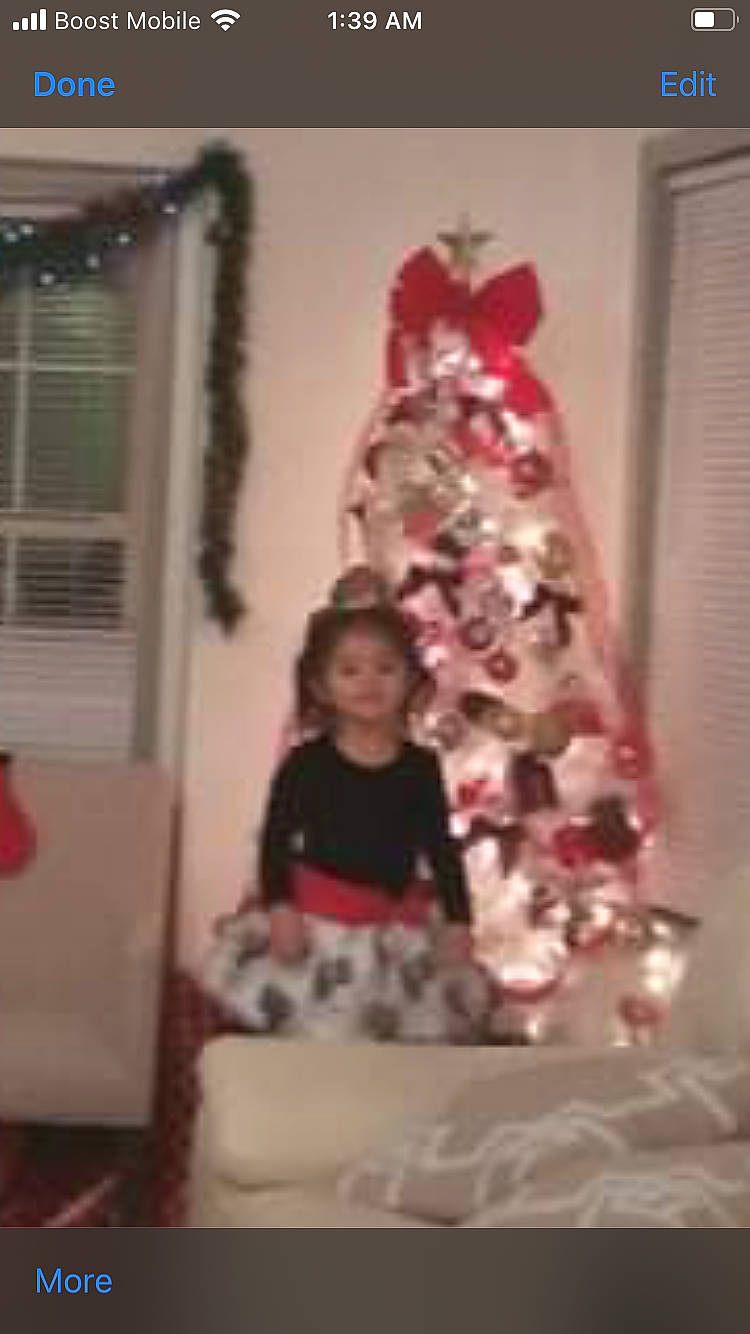 Ximena is registered to the contest to win money with this photo: blurred, christmas, christmas_decoration, christmas_eve, christmas_ornament, christmas_tree, conifer, event, fun, holiday, holiday_ornament, home, interior_design, living_room, magenta, ornament, person, pink, room, toddler