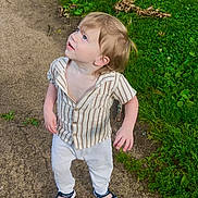 Kase is registered to the contest to win money with this photo: toddler, child, outdoor, grass, path, sandals, striped_shirt, white_pants, curious, blonde_hair, casual_clothing, standing, nature, greenery, young_child, looking_up, daylight, person, portrait, summer