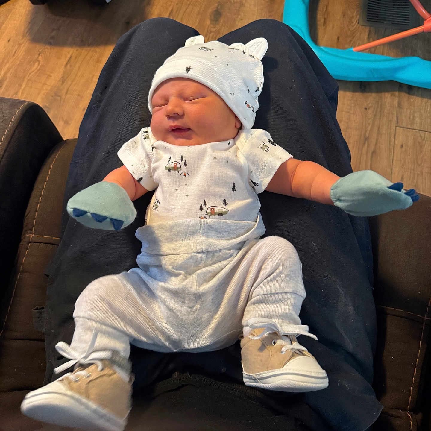 Kyle joined the competition — help win amazing prizes! baby, blue_toy, car_seat, casual, clothing, comfort, cute, hat, home, indoors, infant, lap, mittens, newborn, person, relaxing, resting, shoes, sleeping, wooden_floor