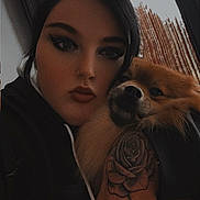 Milo participe au concours pour gagner de l'argent avec cette photo : person, dog, tattoo, hand, face, makeup, window, indoor, pet, fur, portrait, hug, black_clothing, calm, closeup, animal, cozy, casual, expression, home