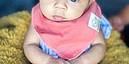 Nylah is registered to the contest to win money with this photo: baby, blue_eyes, yellow_bow, coral_bib, fluffy_blanket, hands, curious_expression, close_up, infant, soft_focus, child, cute, indoor, portrait, skin, person, sitting, clothing, headwear, baby_girl