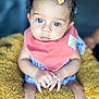 baby, blue_eyes, yellow_bow, coral_bib, fluffy_blanket, hands, curious_expression, close_up, infant, soft_focus, child, cute, indoor, portrait, skin, person, sitting, clothing, headwear, baby_girl