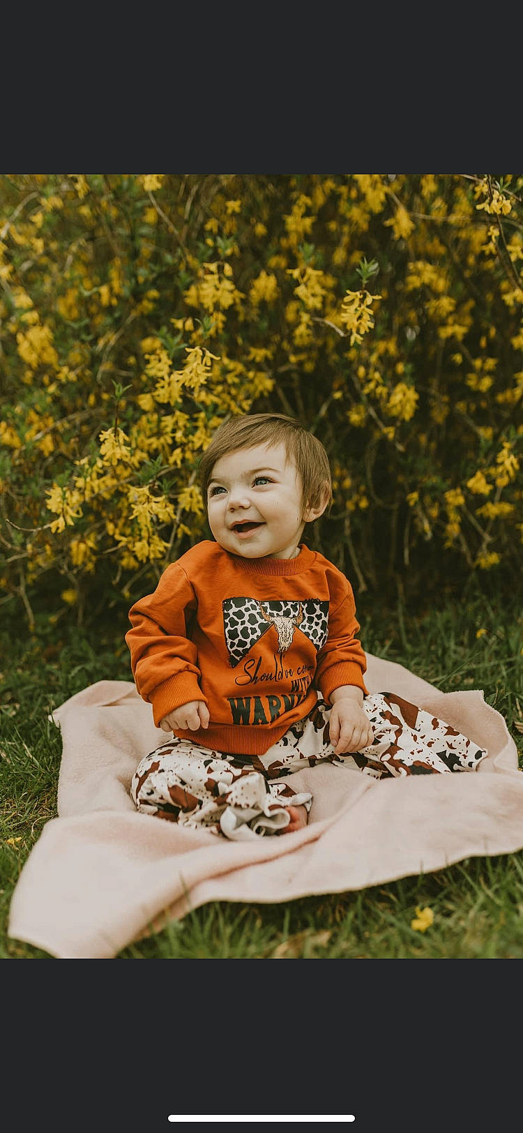 Shae joined the competition — help win amazing prizes! baby, baby_toddler_clothing, child, dress, facial_expression, flower, fun, grass, happy, joy, leisure, orange, pattern, people_in_nature, person, plant, portrait_photography, sitting, smile, t_shirt