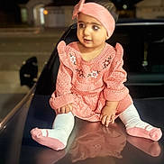 Harish is registered to the contest to win money with this photo: baby, car_hood, child, curious, cute, expression, fashion, feet, headband, knitted_clothing, night, outdoor, person, pink_dress, portrait, reflection, sitting, toddler, warm_clothing, young_child
