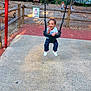 child, toddler, swing, playground, park, fence, trees, man, woman, daylight, smile, happy, casual_clothing, footwear, outdoor, recreation, nature, bench, table, people