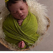 Zaylah is registered to the contest to win money with this photo: newborn, baby, sleeping, wrapped, green_cloth, basket, headband, yellow_pom_pom, cozy, fluffy, infant, peaceful, cute, tiny, portrait, child, soft_texture, resting, adorable, closeup
