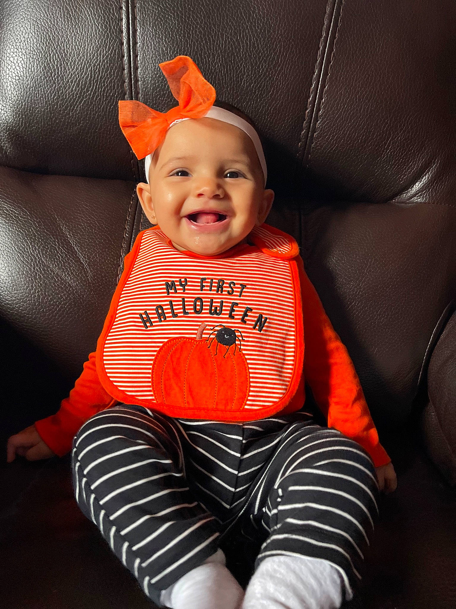 Amiyllah is registered to the contest to win money with this photo: baby, baby_toddler_clothing, car_seat, carmine, comfort, eye, finger, happy, head, headwear, human_body, joy, lap, leg, orange, person, sitting, sleeve, smile, sock