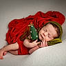 Eliott participe au concours pour gagner de l'argent avec cette photo : newborn, baby, sleeping, red_cloth, green_hat, felt_tree, soft_surface, portrait, holiday_theme, cozy, cute, infant, peaceful, resting, tiny_hands, knitted_hat, christmas, festive, wrapped, indoor