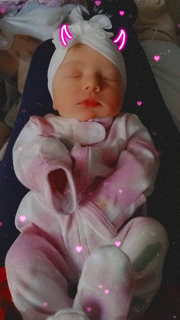 Lotus'Marie is registered to the contest to win money with this photo: baby, baby_products, baby_toddler_clothing, beanie, cap, carmine, cheek, child, comfort, fashion_accessory, head, headgear, linens, magenta, nail, person, personal_protective_equipment, pink, thumb, toddler