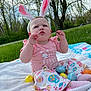 Roselyn joined the competition — help win amazing prizes! baby, blanket, bunny_ears, child, cute, easter, easter_eggs, festive, grass, holiday, nature, outdoor, pastel_colors, pink_clothing, playful, portrait, sitting, spring, trees, young_child
