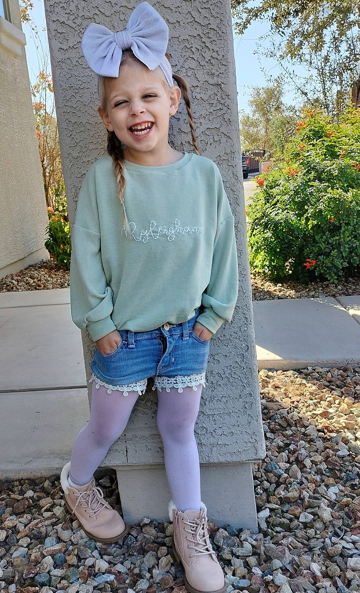 Ryleighann is registered to the contest to win money with this photo: cool, denim, eye, grass, grey, joy, knee, outerwear, person, pink, plant, shoe, shoulder, skin, sleeve, smile, standing, t_shirt, textile, thigh