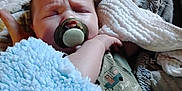 Jase Jr is registered to the contest to win money with this photo: baby, pacifier, blanket, sleeping, infant, cozy, soft, child, cute, wrapped, clothing, furniture, resting, indoors, comfort, peaceful, toddler, nap, expression, face