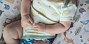 Ruben joined the competition — help win amazing prizes! animal_print, baby, child, chubby_arms, chubby_legs, cushion, cute, diaper_cover, face, happy, head, indoor, infant, onesie, patterned_fabric, person, play_area, resting, smiling, soft_lighting