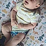 Ruben joined the competition — help win amazing prizes! baby, infant, smiling, cushion, animal_print, onesie, diaper_cover, happy, child, cute, indoor, soft_lighting, patterned_fabric, play_area, chubby_arms, chubby_legs, face, head, person, resting