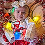 Nala joined the competition — help win amazing prizes! baby, blanket, bow, child, christmas, colorful, cute, decorations, face, festive, happy, headband, holiday_lights, indoors, infant, red_skirt, smiling, soft, tinsel, white_shirt