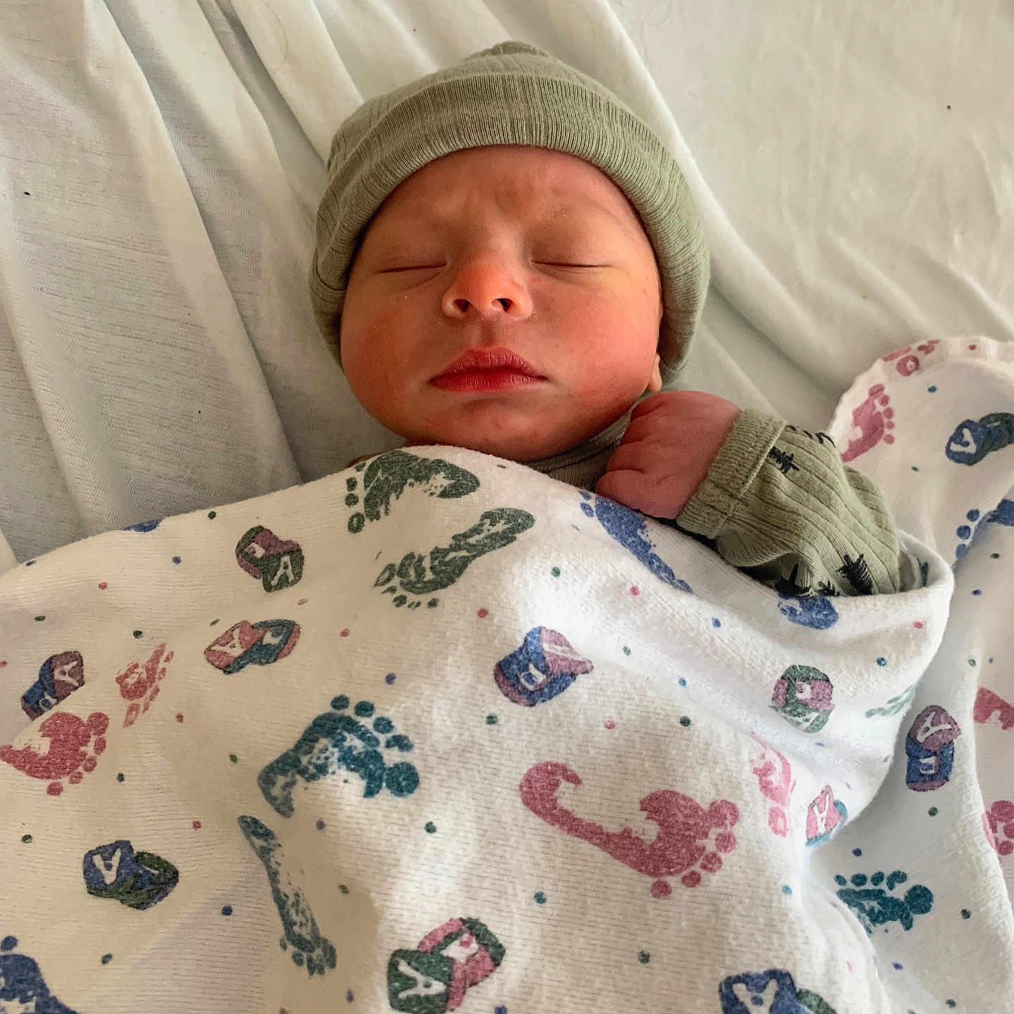 Kyrie is registered to the contest to win money with this photo: architecture, baby, bed, blanket, building, cap, childbirth, clothing, face, furniture, glove, hat, head, hospital, newborn, person, photography, portrait, quilt, sleeping