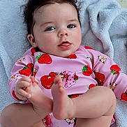 Laynie joined the competition — help win amazing prizes! baby, bare_feet, child, closeup, curly_hair, cute, diaper, expression, happy, indoor, infant, person, pink_clothing, playful, portrait, relaxed, skin, soft_texture, strawberry_pattern, towel
