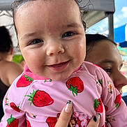 Laynie joined the competition — help win amazing prizes! baby, child, person, smile, face, pink_clothing, strawberry_pattern, wet_hair, hand, manicure, outdoor, tent, sky, happy, cute, portrait, closeup, holding, people, background