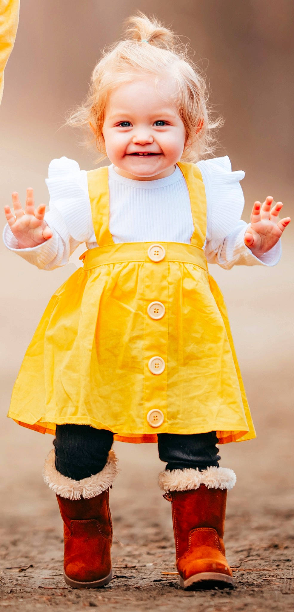 Emery is registered to the contest to win money with this photo: baby_toddler_clothing, cheek, facial_expression, finger, gesture, hand, happy, joint, joy, neck, nose, one_piece_garment, orange, person, pink, shoulder, skin, sleeve, smile, standing