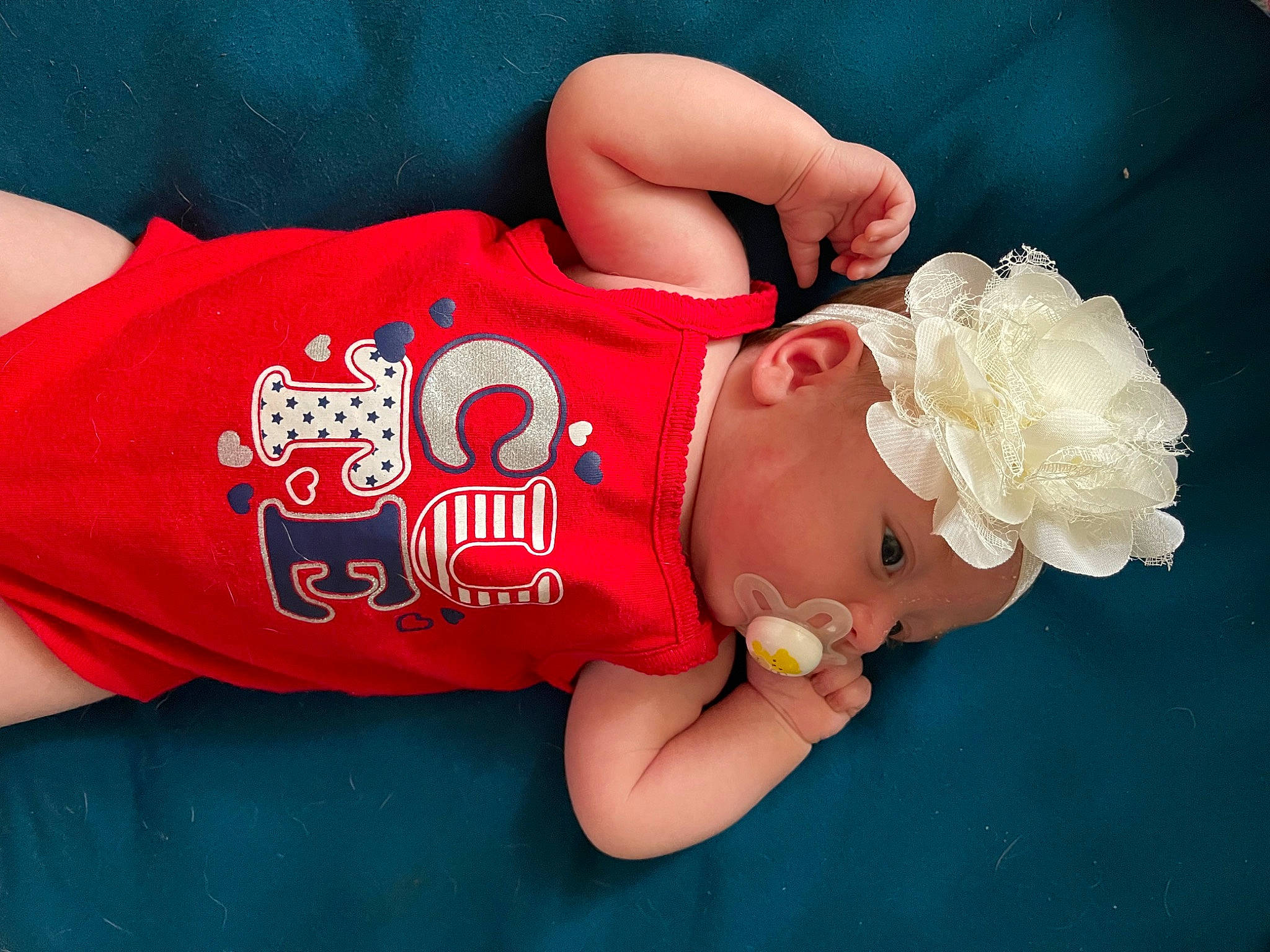 Scarlett joined the competition — help win amazing prizes! abdomen, baby, baby_toddler_clothing, chest, child, elbow, finger, gesture, hand, happy, headgear, headwear, human_body, person, pink, sleeve, t_shirt, textile, thigh, toddler