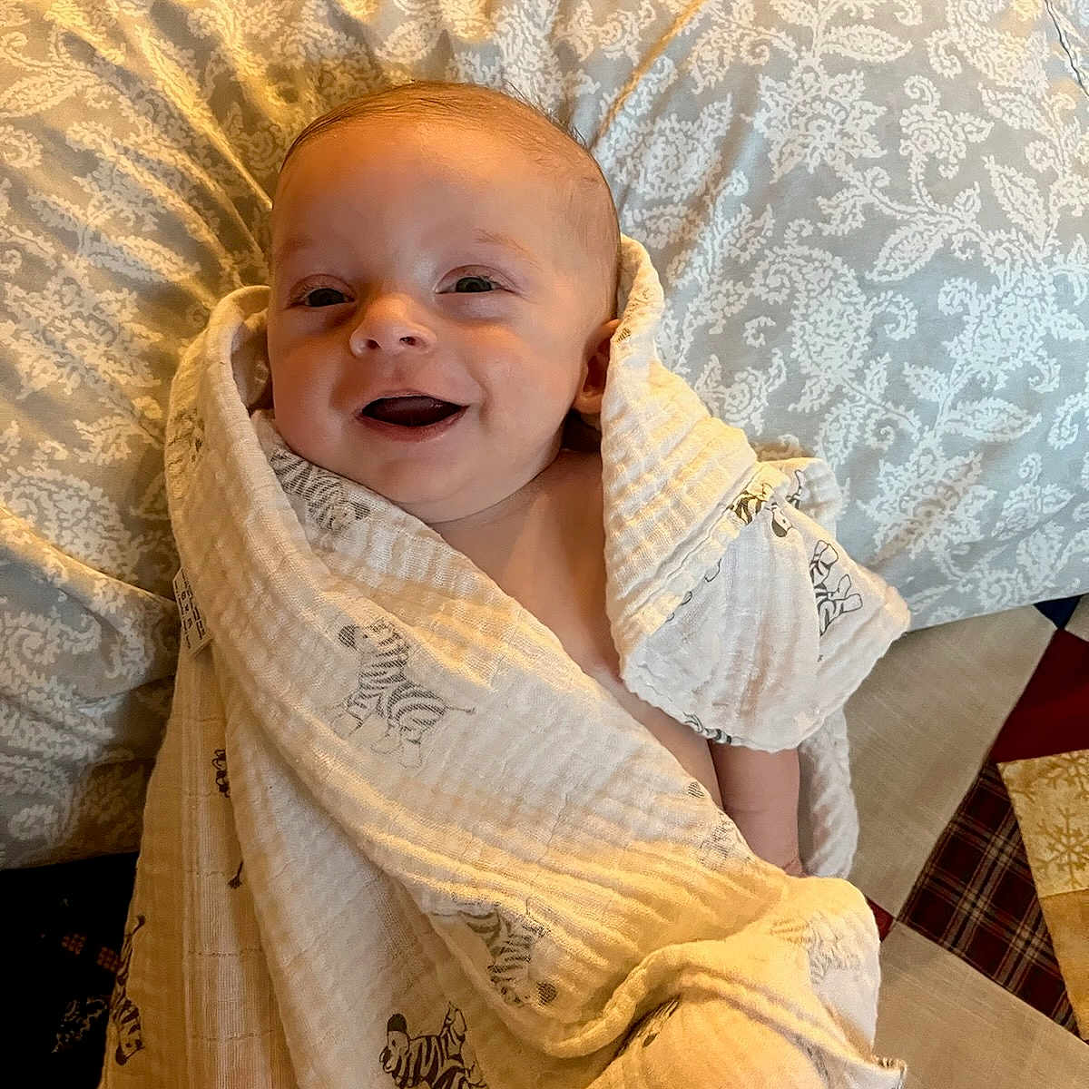 Ronan is registered to the contest to win money with this photo: baby, babylaughing, blanket, couch, cushion, face, furniture, happy, head, homedecor, laughing, newborn, person, photography, portrait, quilt, smile, towel