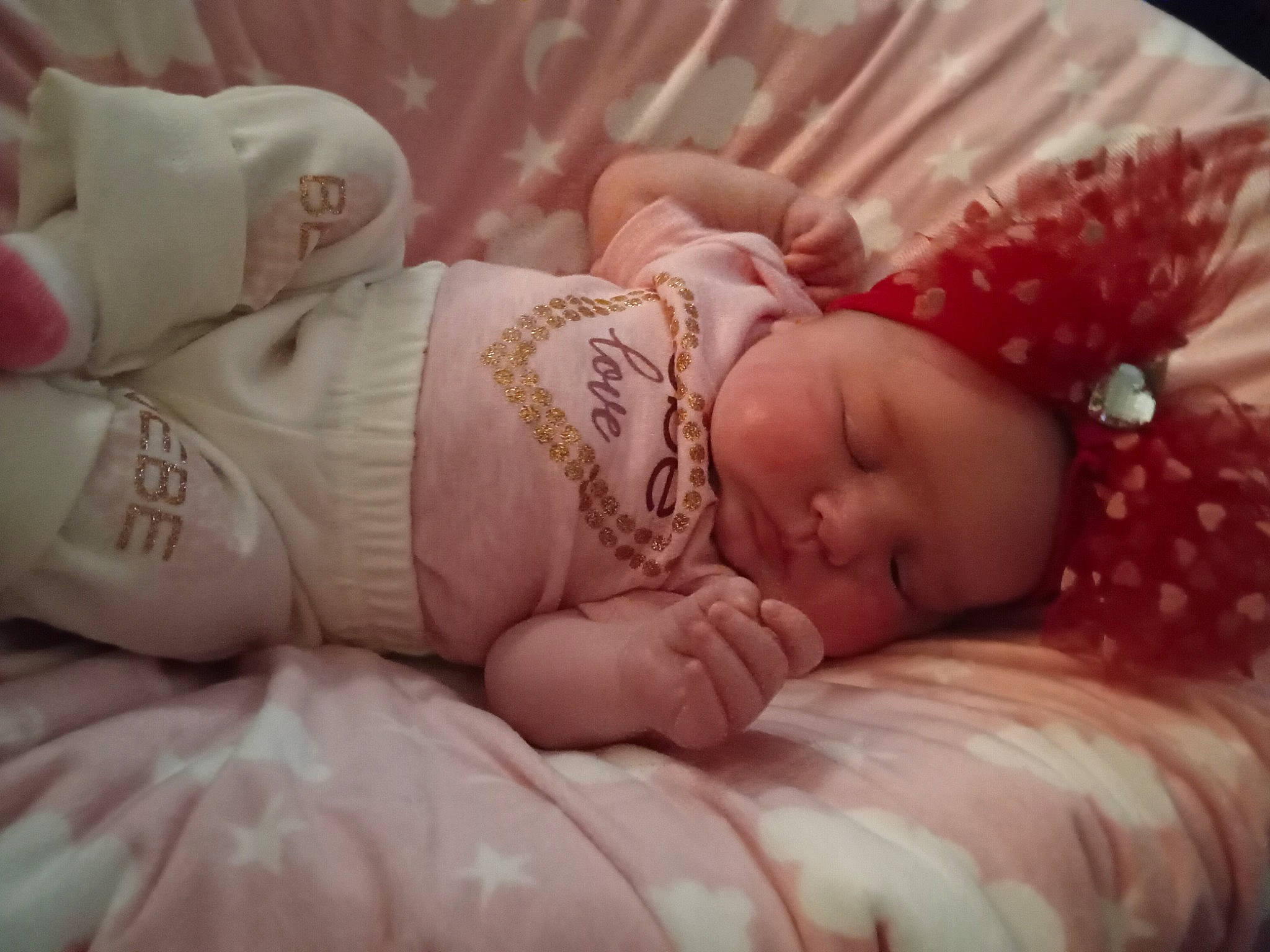 Harlynn is registered to the contest to win money with this photo: arm, baby, baby_sleeping, baby_toddler_clothing, child, comfort, dress, eyelash, facial_expression, finger, hand, headgear, headwear, human_body, lip, mouth, nail, person, pink, skin